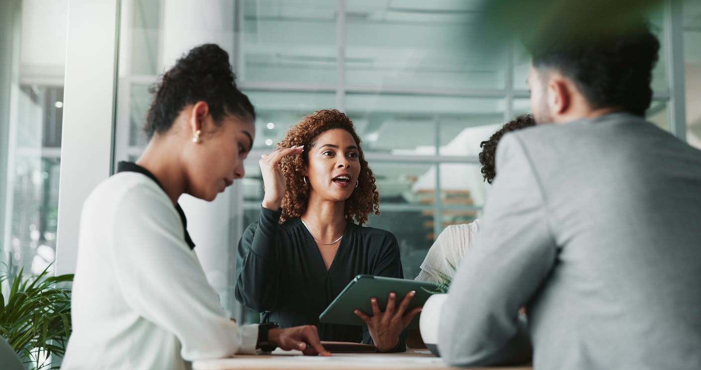 Woman, lawyer and tablet at meeting with team, planning and discussion for review for legal case in office\. People, attorney and digital touchscreen with group, negotiation and feedback at law firm